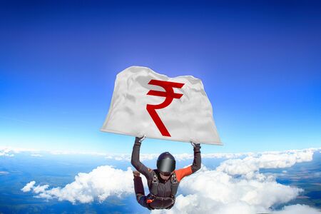 Rupees. Men in parachute equipment. Skydiving sport. Extreme hobby as a way of life. Parachuting. Men in free fall.の写真素材