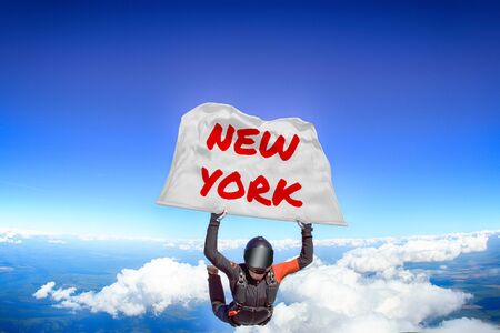 New York. Men in parachute equipment. Skydiving sport. Extreme hobby as a way of life. Parachuting. Men in free fall.の写真素材
