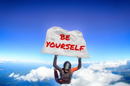 Be yourself. Men in parachute equipment. Skydiving sport. Extreme hobby as a way of life. Parachuting. Men in free fall.の写真素材