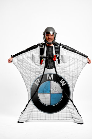 BMW. Bird men. Men in wing suit equipment.Demonstration of popular brands. Simulator of free fall.のeditorial素材