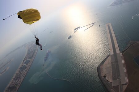 Up. Fly men is a pilot of his body in air. Extreme people prefer skydiving. Parachutist in black suit. Free lifestyle.の写真素材