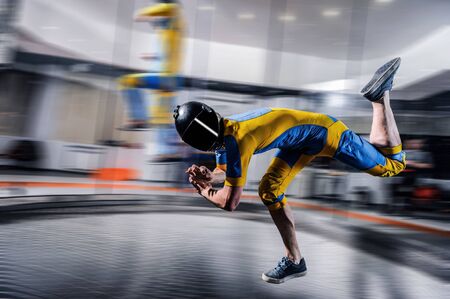 Speed. Fly men is a pilot of his body in air. Extreme people prefer skydiving. Parachutist in blue...
