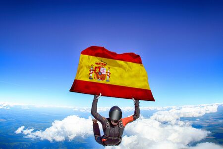 Spain flag travel. Men in parachute equipment. Skydiving men in parashute.の写真素材