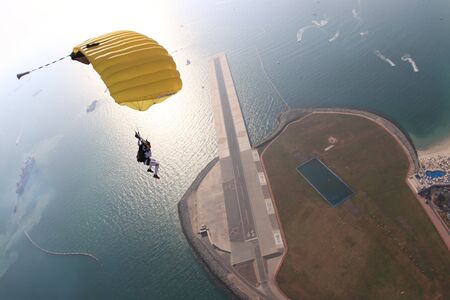 Up. Fly men is a pilot of his body in air. Extreme people prefer skydiving. Parachutist in black suit. Free lifestyle.の写真素材
