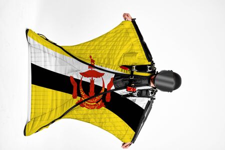 Brunei flag. Men in wing suit templet. Skydiving men in parashute. Simulator of free fall.の写真素材