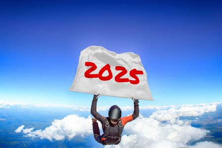 2025. Flag in skydiving. People in free fall.Teampleat skydiver. Extreme sport.の写真素材
