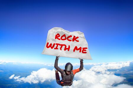 Rock with me. Flag in skydiving. People in free fall.Teampleat skydiver. Extreme sport.の写真素材