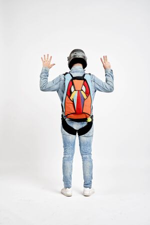 Eight fingers. Men in parachute shows eight fingers. Gesture by fingers. Skydiving sport.の写真素材