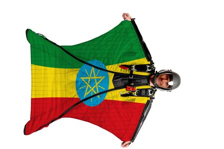 Ethiopia flag. Men in wing suit templet. Skydiving men in parashute. Simulator of free fall.の写真素材