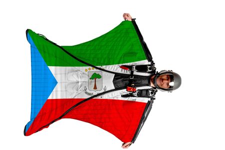 Equatorial Guinea flag. Men in wing suit templet. Skydiving men in parashute. Simulator of free fall.の写真素材