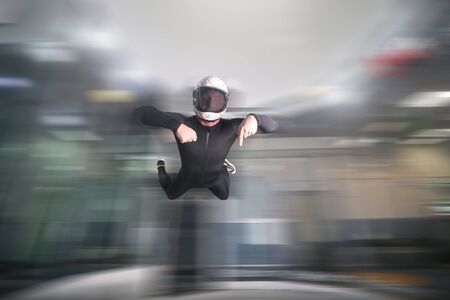 Finger down. Men in parachute shows finger down gesture. Gesture by fingers. Skydiving sport.の写真素材