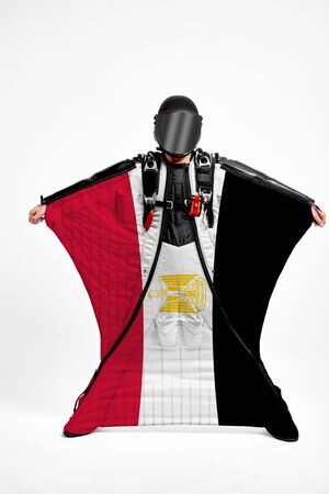 Egypt extreme. Men in wing suit templet. Skydiving men in parashute. Simulator of free fall.の写真素材