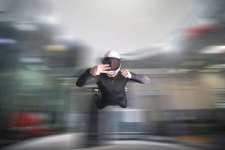 Three finfers. Men in parachute shows three fingers. Gesture by fingers. Skydiving sport.の写真素材