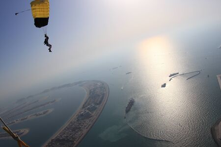 Up. Fly men is a pilot of his body in air. Extreme people prefer skydiving. Parachutist in black suit. Free lifestyle.の写真素材