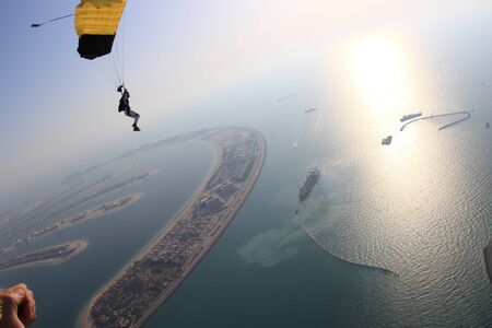 Adrenaline. Free people prefere active sports. Bird men conquers sky. Flying people in black suit. Extreme as a hobby.の写真素材
