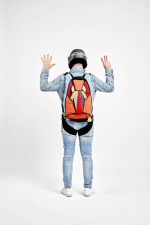 Eight fingers. Men in parachute shows eight fingers. Gesture by fingers. Skydiving sport.の写真素材