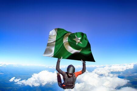 Pakistan extreme. Flag in skydiving. People in free fall grab flag of Pakistan. Patriotism, men and flag.の写真素材