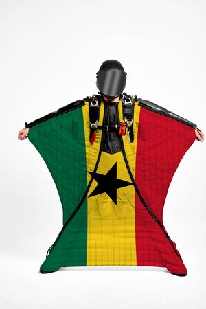 Ghana extreme. Men in wing suit templet. Skydiving men in parashute. Simulator of free fall.の写真素材