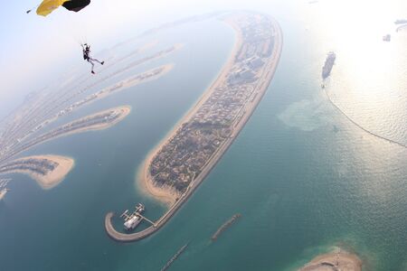Skydiving. Fly men is a pilot of his body in air. Extreme people prefer skydiving. Parachutist in black suit. Free lifestyle.の写真素材