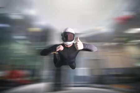 Gesture of approval. Men in parachute shows class by finger. Gesture by fingers. Skydiving sport.の写真素材