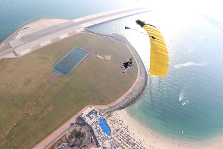 Speed. Extreme people prefere sky sport. Fly men perfoms trick in air. Parachutist in black suit is in free fall. Skydiving is sport without rules.の写真素材
