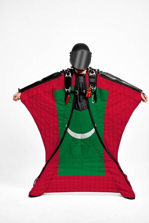 Maldives extreme. Men in wing suit templet. Skydiving men in parashute. Simulator of free fall.の写真素材