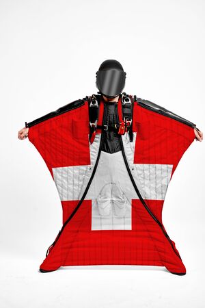 Switzerland extreme. Men in wing suit templet. Skydiving men in parashute. Simulator of free fall.の写真素材