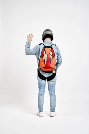 Four finfers. Men in parachute shows four fingers. Gesture by fingers. Skydiving sport.の写真素材