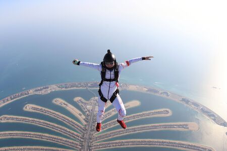 Risk. Brave men in parachute equipment. Skydiving is sport for extreme people. Flyer in white suit. The sky without borders.の写真素材