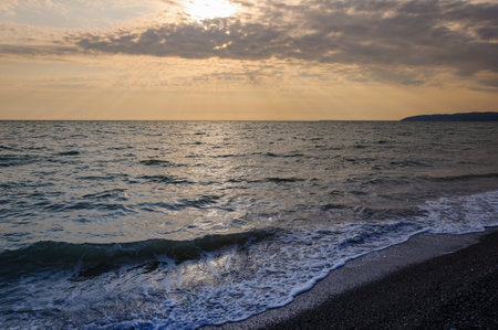 sea beach sunset with cloudsの写真素材