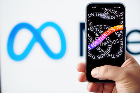 Moscow, Russia, 08-07-2023: Man arm holds smartphone with Threads app startup logo on screen. Instagram Threads app from Facebook Meta. New micro blogging platform as Twitter competitor.のeditorial素材