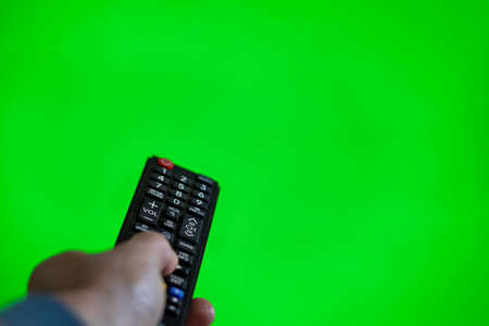 TV remote control on green chroma screenの写真素材