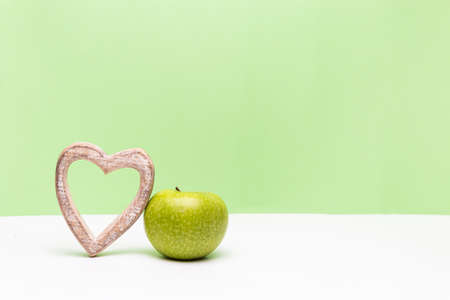 Apple and heart on horizontal green and white backgroundの写真素材