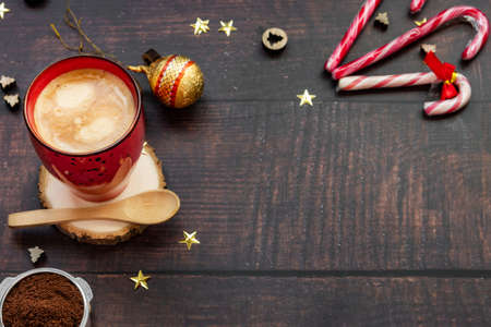Coffee with milk on wooden background with christmas decorationの写真素材