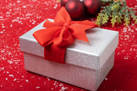 Horizontal christmas decoration on red background and snow
