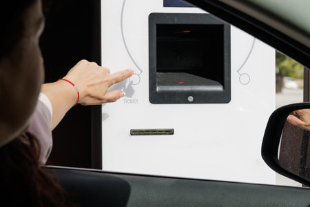 Taking out parking ticket from the car.の写真素材