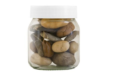 transparent jar with different stones on white backgroundの写真素材