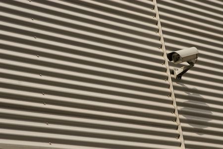 detail of surveillance camera mounted on metal facade