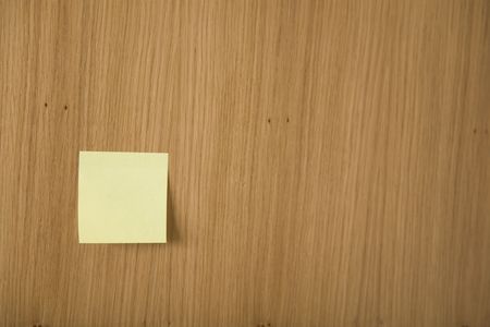 yellow post it on wooden boardの写真素材