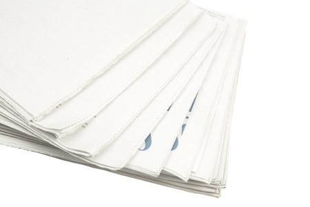 front view of piled up newspapers isolated on a white background の写真素材