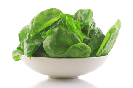 front view of fresh spinach in a white bowl の写真素材
