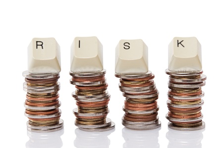 Keyboard Letter Spelling Risk Atop Coin Stacks 