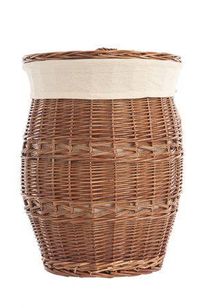 Isolated on white laundry basket made of rattanの写真素材