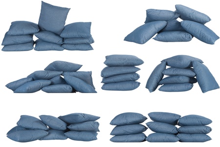 seven stacks of blue denim pillows isolated on whiteの写真素材