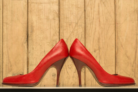 pair of red high heels on old wood backgroundの写真素材