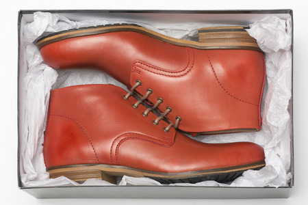 new red shoes in box with wrapping paperの写真素材