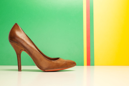 brown high heels on yellow and green backgroundの写真素材