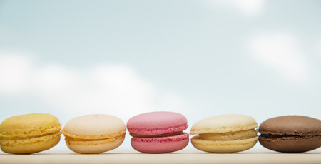 Colorful macaroons, French pastry on sky backgroundの写真素材