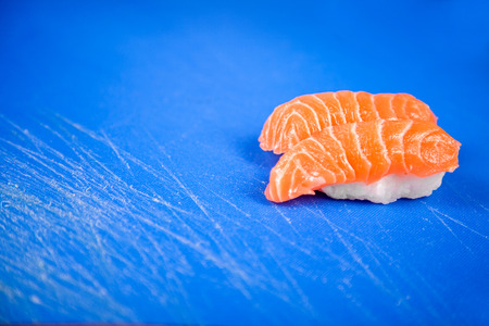 Japanese seafood ready for sushi on blue chopped boardの写真素材