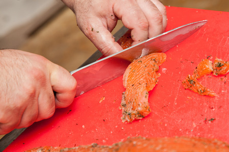 Chef Cutting salmon fish and preparing sushiの写真素材